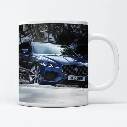 Jaguar XF Blue Sedan Driving Through Snow