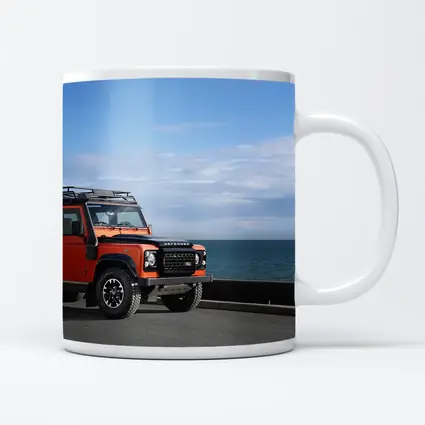 Land Rover Defender Orange Coastal Road Scene