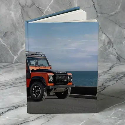 Land Rover Defender Orange Coastal Road Scene