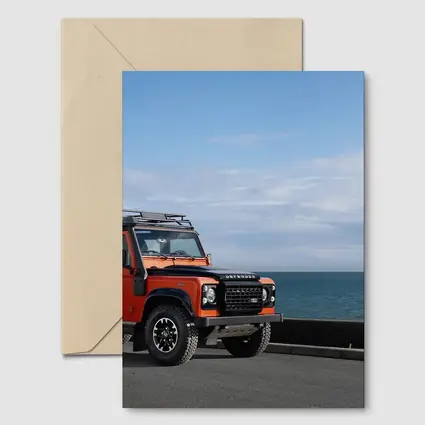 Land Rover Defender Orange Coastal Road Scene