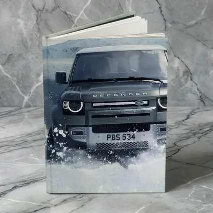 Land Rover Defender Charging Through Snow Landscape