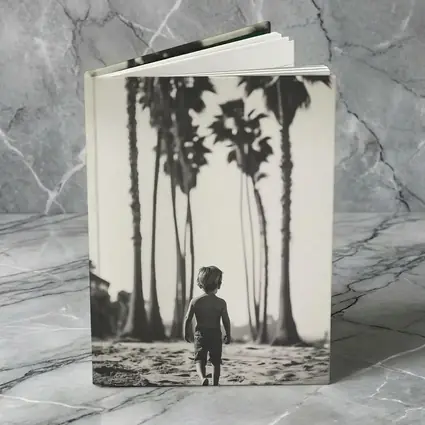 Boy Walking on Beach Among Palm Trees