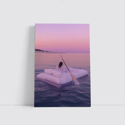 Woman Floating on Raft at Pink Sunset