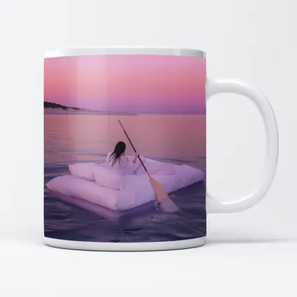 Woman Floating on Raft at Pink Sunset