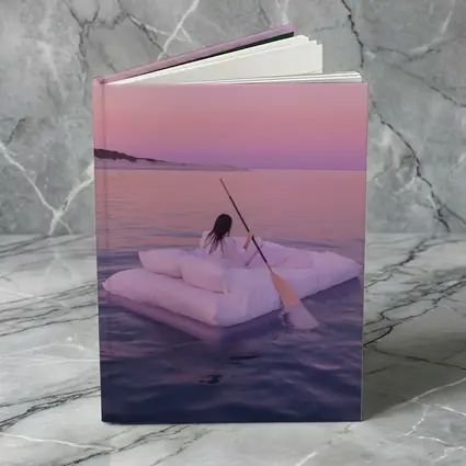 Woman Floating on Raft at Pink Sunset