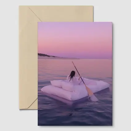 Woman Floating on Raft at Pink Sunset