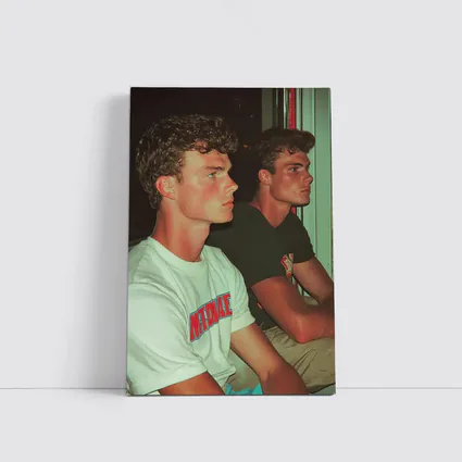 Two Young Men Sitting Together Indoors
