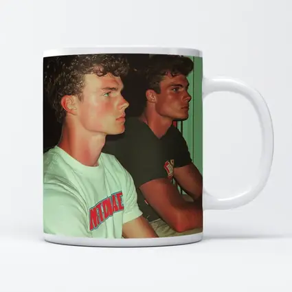 Two Young Men Sitting Together Indoors