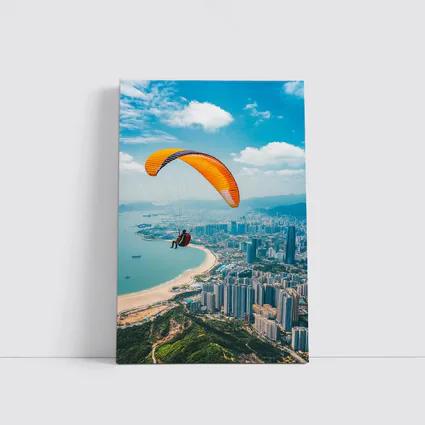 Paraglider Soaring Over Coastal City Skyline