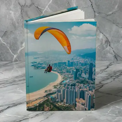 Paraglider Soaring Over Coastal City Skyline