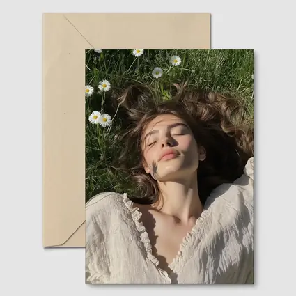 Young Woman Lying in Daisy Flower Field