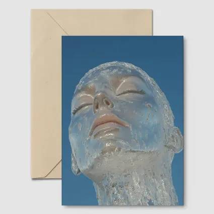 Ice Face Sculpture Against Blue Sky