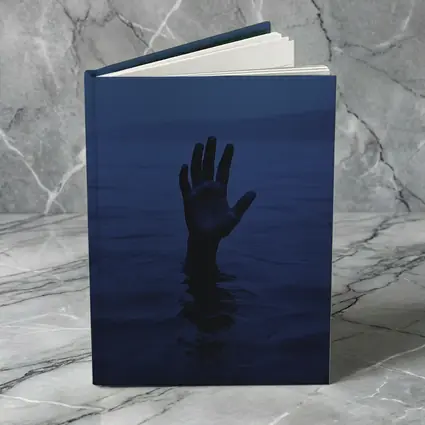 Hand Reaching From Dark Blue Ocean Water