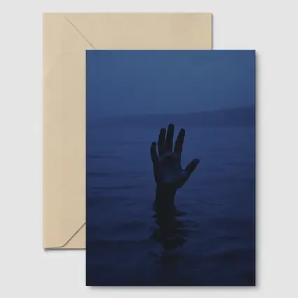 Hand Reaching From Dark Blue Ocean Water