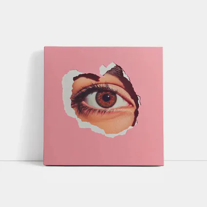 Brown Eye Peering Through Torn Pink Paper