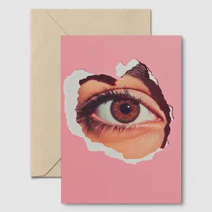 Brown Eye Peering Through Torn Pink Paper