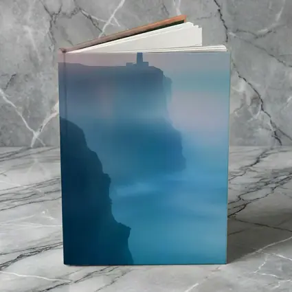 Lighthouse on Misty Cliffs at Sunset