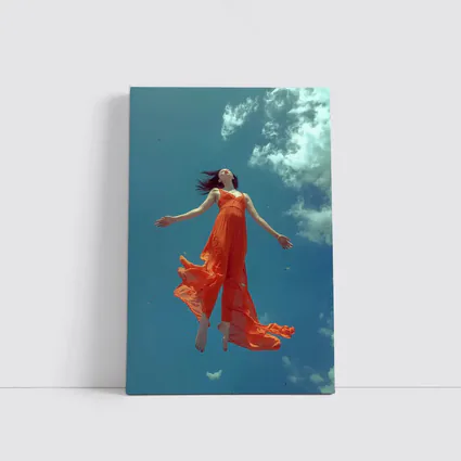 Woman Floating in Blue Sky Orange Dress