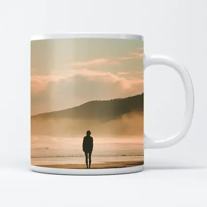 Lone Woman Standing On Misty Beach Shore