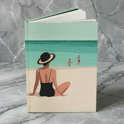 Woman In Hat Sitting On Beach