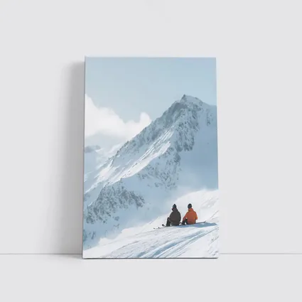 Two Skiers Resting On Snowy Mountain Peak
