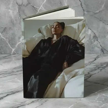 Woman in Black Silk Resting on White Sofa