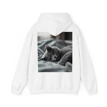 British Shorthair Cat Resting On Gray Bedding