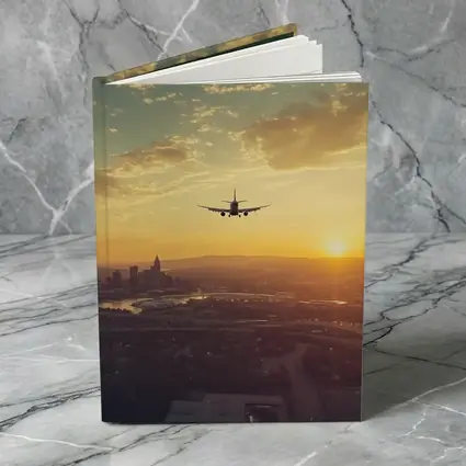 Airplane Silhouette Flying Over City Sunset