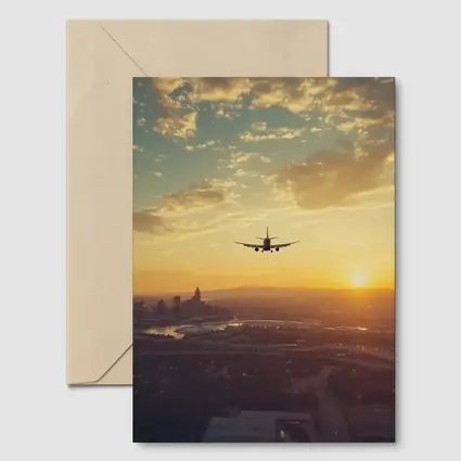 Airplane Silhouette Flying Over City Sunset
