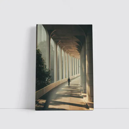 Lone Figure Walking Sunlit Arched Corridor