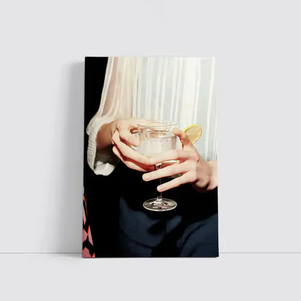Hands Holding Cocktail Glass With Lemon