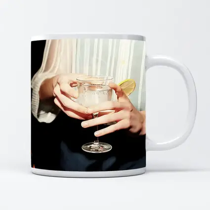 Hands Holding Cocktail Glass With Lemon
