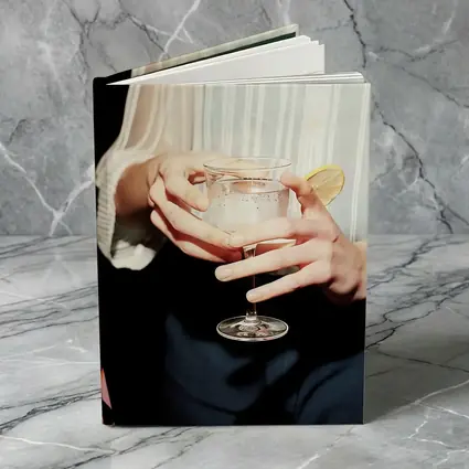 Hands Holding Cocktail Glass With Lemon