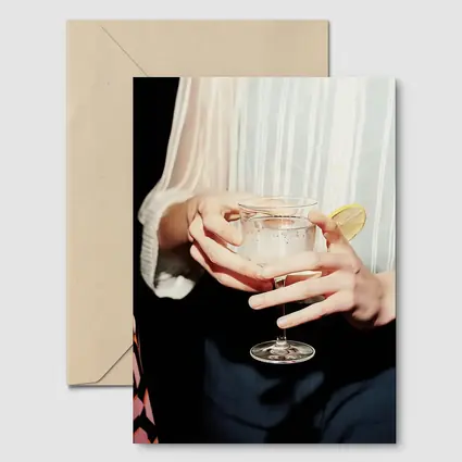 Hands Holding Cocktail Glass With Lemon