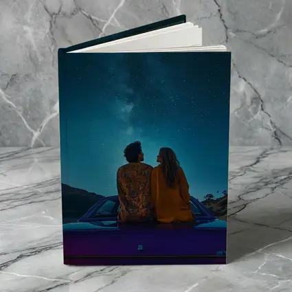 Couple Sitting on Car Under Starry Sky