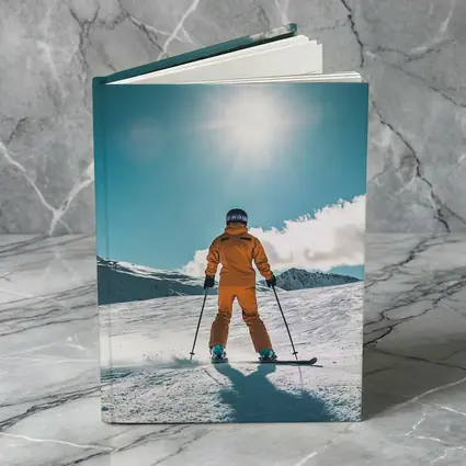 Skier In Orange Suit Sunny Snow Mountain