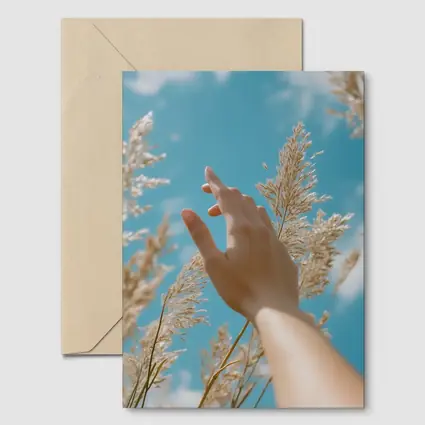 Hand Reaching Through Golden Wheat Blue Sky