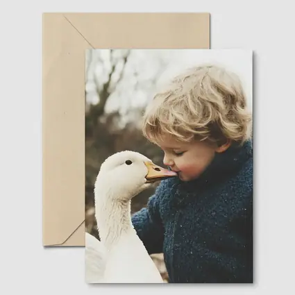 Child Kissing White Goose Outdoors