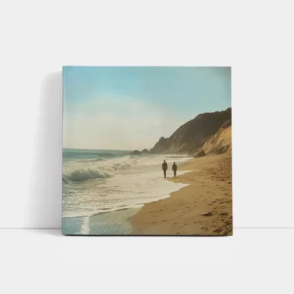 Two People Walking Along Sunny Beach Shore