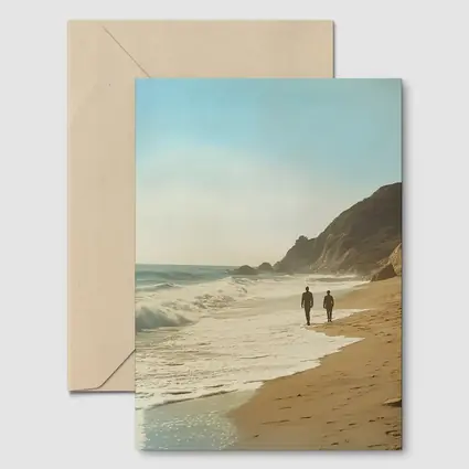 Two People Walking Along Sunny Beach Shore