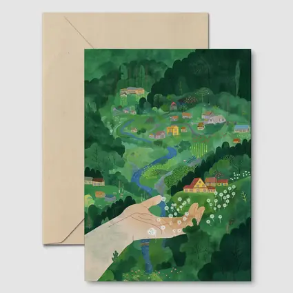Hand Holding Dandelions Over Green Village