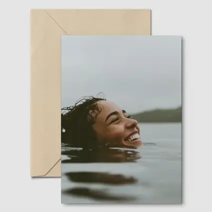 Smiling Woman Swimming In Misty Lake