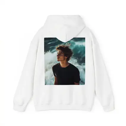 Young Man Standing By Ocean Waves