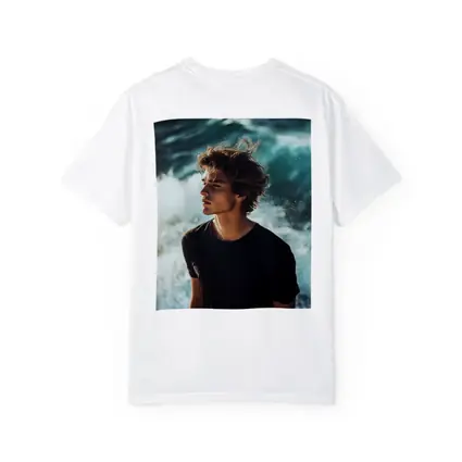 Young Man Standing By Ocean Waves