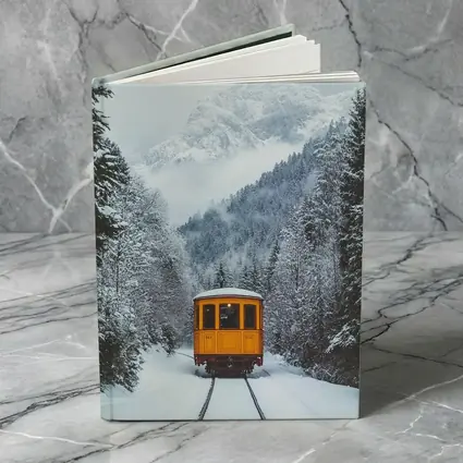 Yellow Train Passing Through Snowy Mountain Forest