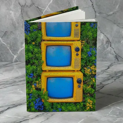 Yellow Retro TVs Stacked Among Wildflowers
