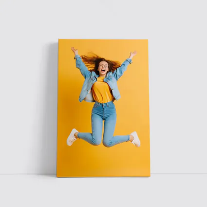 Happy Girl Jumping On Yellow Background
