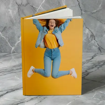 Happy Girl Jumping On Yellow Background