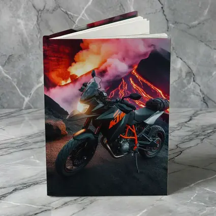 KTM Motorcycle Parked Near Erupting Volcano