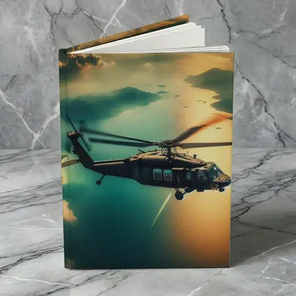Black Hawk Helicopter Flying Over Coastal Landscape